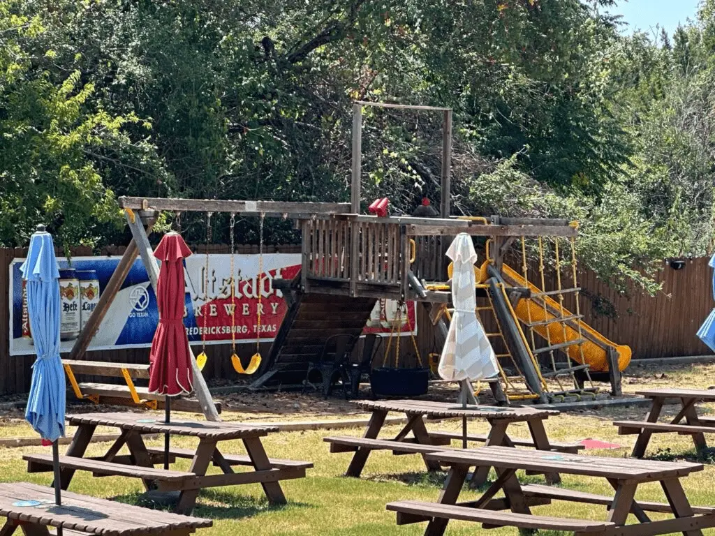 lake travis biergarten playground by picnic tables