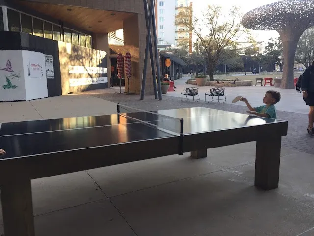 A child plays ping pong at Culinary Dropout at the Domain