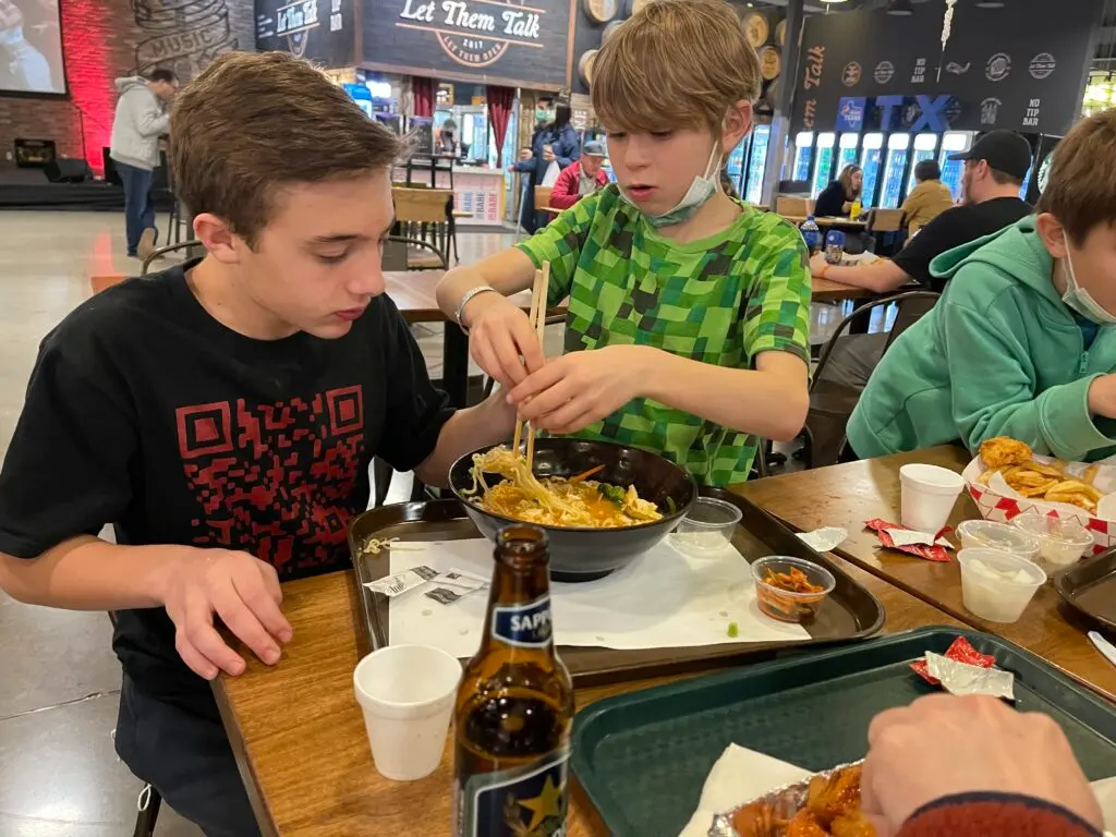 Kids eating ramen at H Mart in Austin