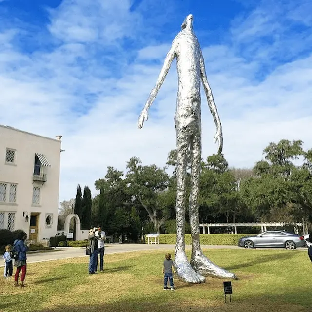 Child looking up at a statue at Laguna Gloria in Austin, free on Thursdays